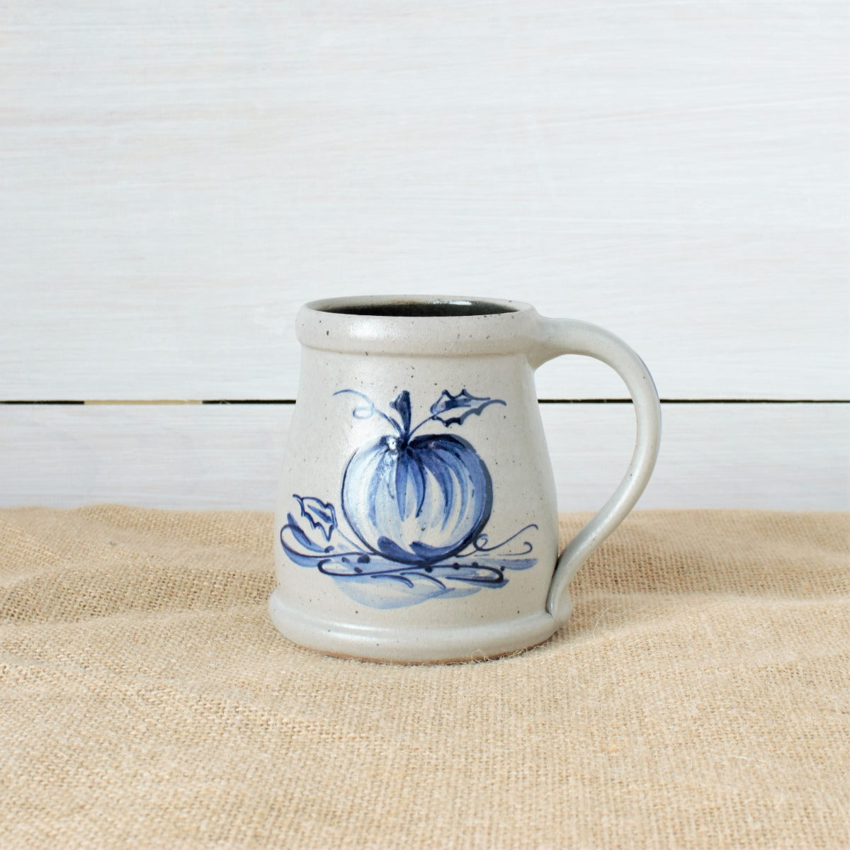 Rowe Pottery Hand thrown stoneware mug In a hand decorated pumpkin pattern