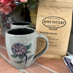 Rowe Pottery Hand thrown stoneware mug In a hand decorated Peony pattern with rowe pottery botters blend in the background