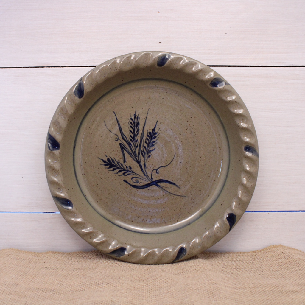 Rowe Pottery handmade stoneware pie plate with Wheat pattern on wood background